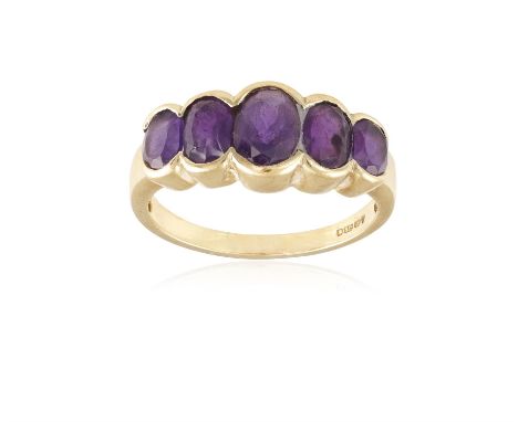 AN AMETHYST FIVE-STONE RING, composed of five graduated oval-shaped amethysts, mounted in 9K gold, ring size N