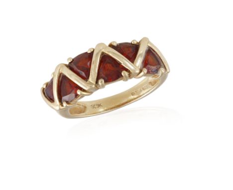 A GARNET RING, composed of fancy-cut garnets, mounted in 9K gold, ring size L