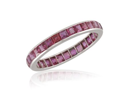 A RUBY ETERNITY RING, composed of a single row of channel-set calibré-cut rubies, ring size V¾