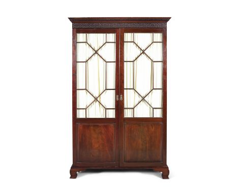 A GEORGIAN STYLE MAHOGANY TWO-DOOR WARDROBE, with moulded cornice, above twin astragal glazed doors, on outset bracket feet. 