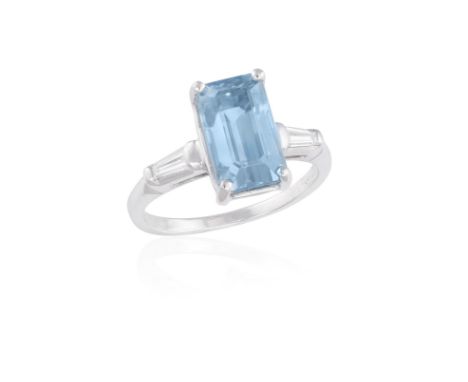 A BLUE ZIRCON AND DIAMOND RING, the rectangular-cut blue zircon weighing approximately 5.80cts within a four-claw setting bet