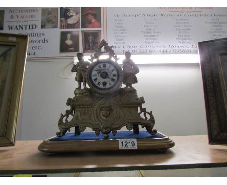 A french gilt mantel clock surmounted figures