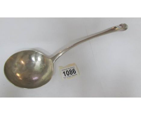 A heavy silver ladle