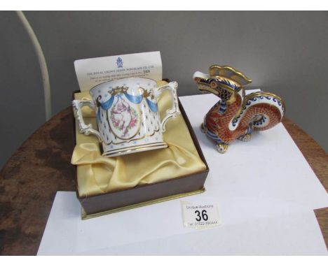 A Royal Crown Derby birth of Prince William loving cup and a silver button oriental dragon paper weight