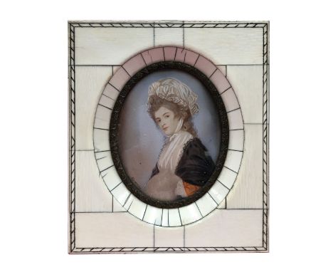 An antique hand painted miniature portrait of a lady, signed Romney