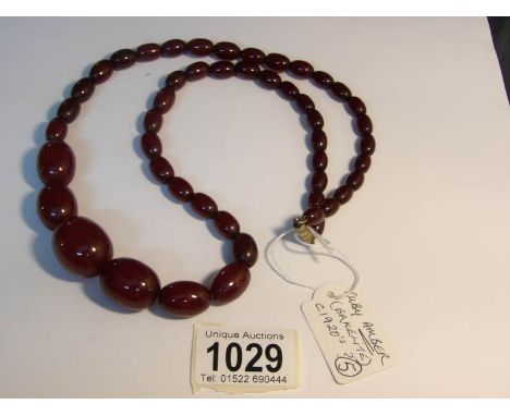 A ruby amber (bakelite?) or cornelian necklace