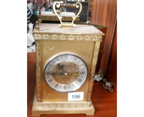 A brass mantel clock