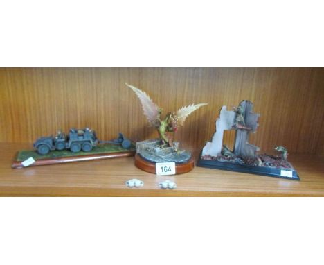A model dragon and 2 models of war scenes