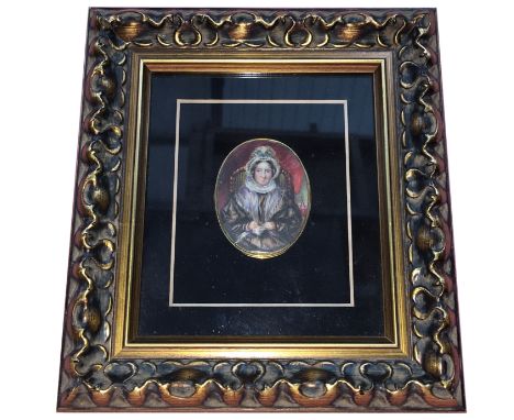 An early 19th century hand painted miniature portrait of an elderly lady with hair in rear and in gold mount with initial L i