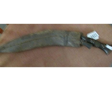 A Kukri with skinning knives in scabbard