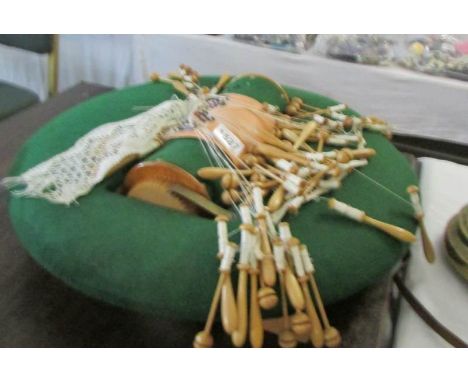 A lace makers cushion with bobbins