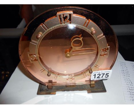 An Art Deco amber glass mantel clock