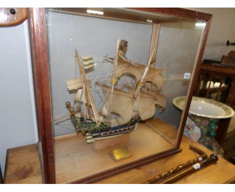 A cased model of a galleon with presentation plaque reading 'presented to Miss Wren, April 1938'
