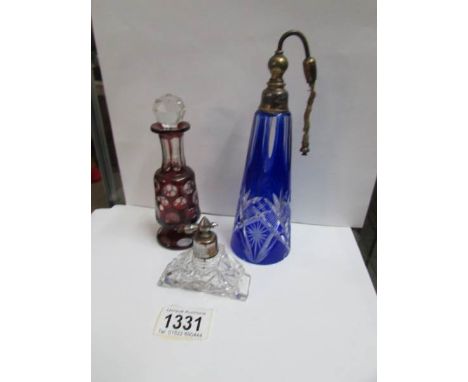 A ruby overlaid glass scent bottle (wrong stopper), a blue cut glass scent bottle and one other