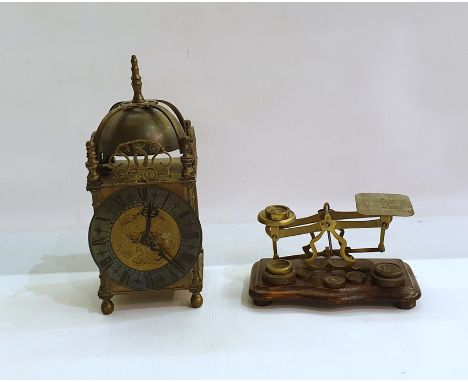 Brass lantern-style clock, the insides have been removed and replaced with a quartz movement and a set of postal scales with 