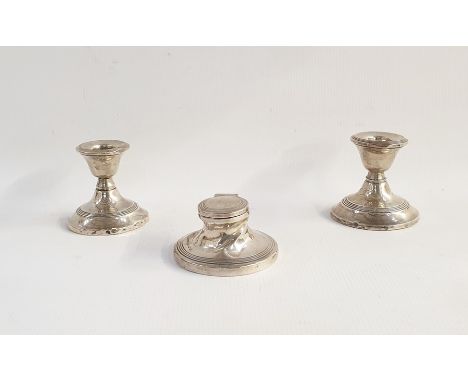 Squat capstan-style silver inkwell with reeded decoration and two similarly decorated squat candlesticks (3) 