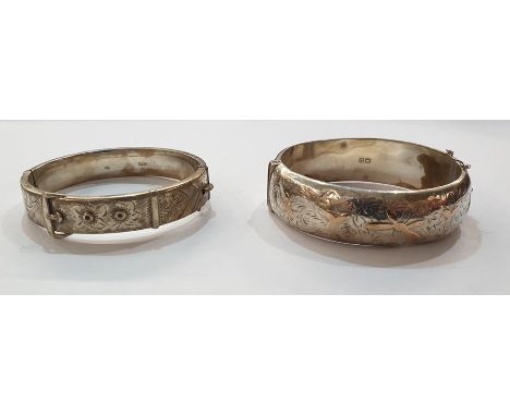 Silver bangle of belt and buckle design with scroll engraving and another silver gold applied bangle,&nbsp;floral decorated (