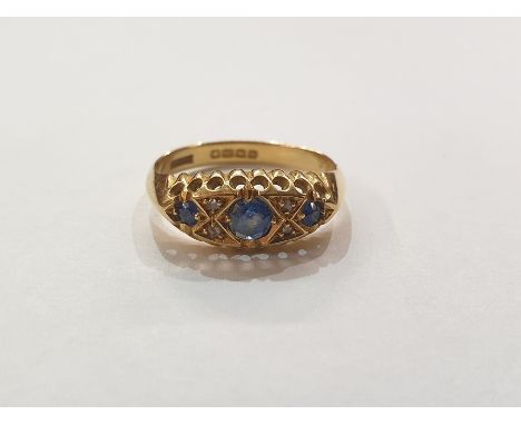 18ct gold, sapphire and diamond dress ring, the elliptical setting with three sapphires and four small diamonds, Birmingham 1