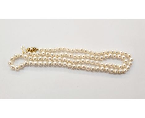 String of cultured pearls with 18ct gold bow-pattern clasp set with single pearl, 75cm long 