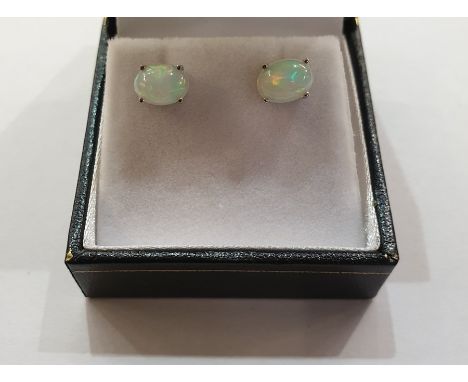 Pair of white metal Ethiopian opal stud earrings, each with oval cabochon stone 