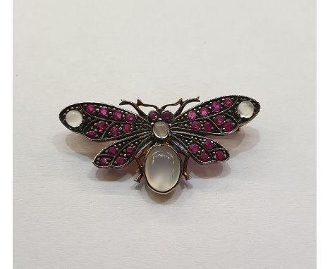 Silver coloured metal and gilt, ruby and moonstone butterfly brooch having four cabochon moonstones and multiple small rubies