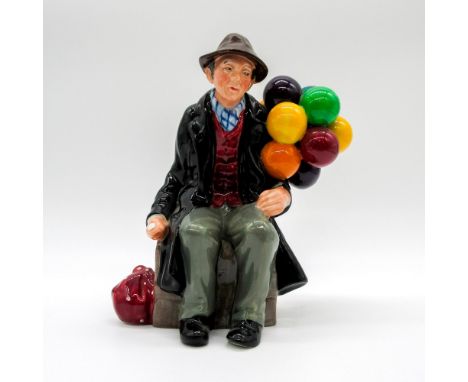 Seated figure of a man with balloons. Black and burgundy coloration. Royal Doulton backstamp. This item has no reserve. Artis