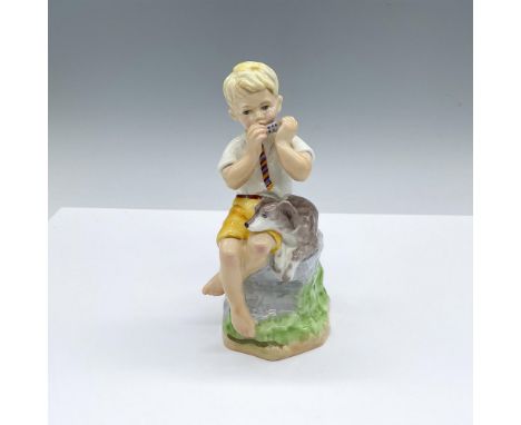 Hand decorated figure of a young boy playing on the harmonica. A dog resting on beside him. Royal Worcester backstamp. Artist