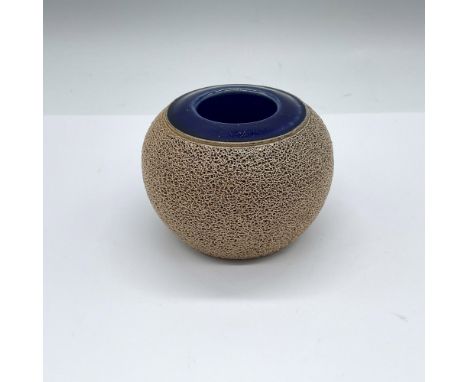 A round ceramic match striker, with a blue glaze pocket to store matchsticks. Royal Doulton impressed stamp. Issued: 1922-195