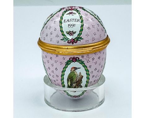 A pretty box in shades of pink, white, and green, adorned with repeating oval windows that showcase a variety of colorful bir