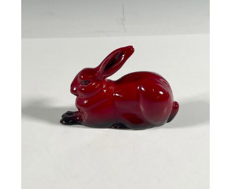 This exquisite animal figurine features a hare poised gracefully in a crouched position, beautifully rendered in a rich red g