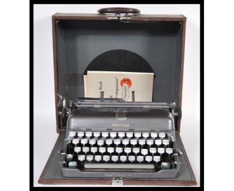 A vintage mid 20th Century Imperial portable typewriter complete in its original carry case. Measures 13 cm high x 36 cm wide