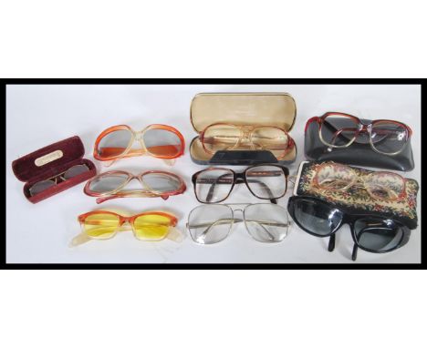 A collection of vintage retro 20th Century sunglasses to include mostly examples with plastic frames. Some cased examples pre