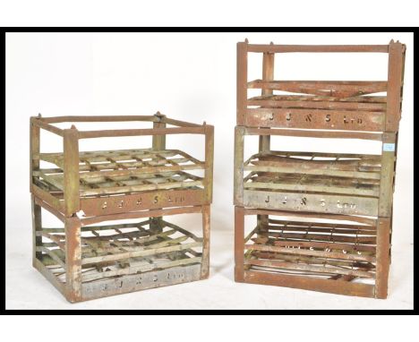 A set of five vintage retro 20th Century sheet metal bottle racks having pierced notation for JJ&amp;S Ltd.