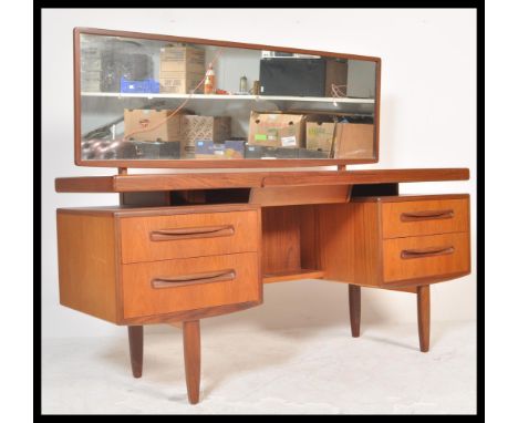 A vintage retro 20th Century retro teak wood G-Plan Kelso dressing table having pedestals of drawers raised over tapered supp