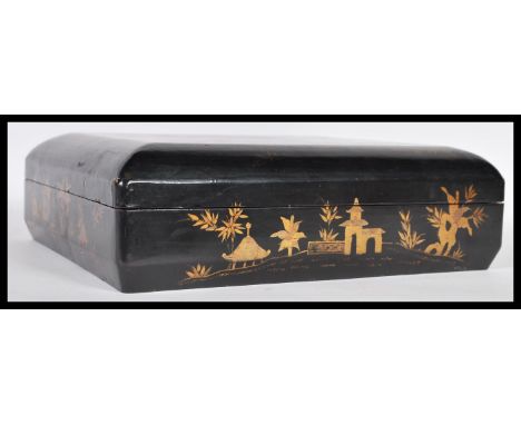 An early 20th Century Chinese black lacquer games box of cushion form having five sectional fitted lidded boxes to interior c