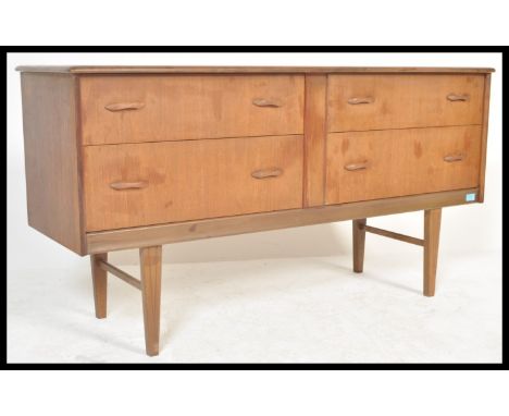 A vintage Danish influence retro 20th Century teak wood sideboard of small proportions having four drawers raised on tapering