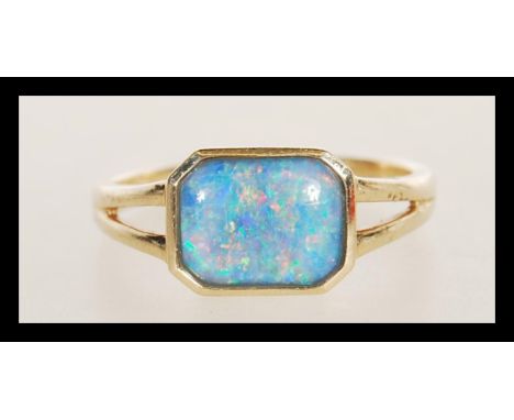 A hallmarked 9ct gold ring having a central octagonal bezel set opal cabochon doublet. Weighs 1.9 grams size M.