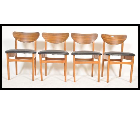 A set of four vintage retro 20th Century teak wood dining chairs raised on square legs with black vinyl seats and shaped wood