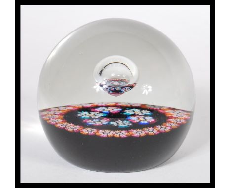 A vintage 1970's Caithness William Manson studio art glass paperweight having millefiori canes and central bubble. Central bu