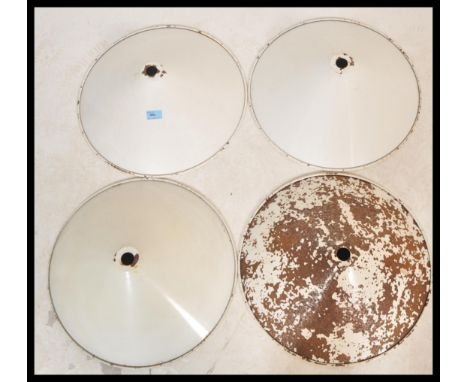 A set of four vintage retro 20th Century industrial factory pendant light shades of UFO form having a white enamel finish. Me