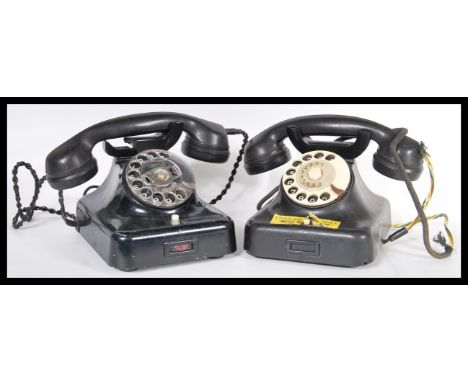A pair of vintage 20th Century retro industrial office bakelite ring dial telephones having ring dial fronts with speaker mou