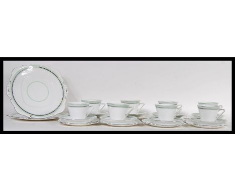 A 20th Century Art Deco Tuscan china English tea service consisting of two large cake plates, six cup saucer side plate trios