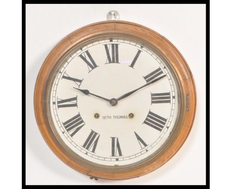 An early 20th Century Edwardian mahogany cased Station clock, the circular clock with Roman numeral chapter ring, eight day m