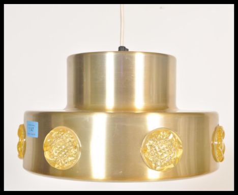 A vintage retro 20th Century two step gold tone ceiling light fixture having applied plastic medallion prunt's. Measures 18cm