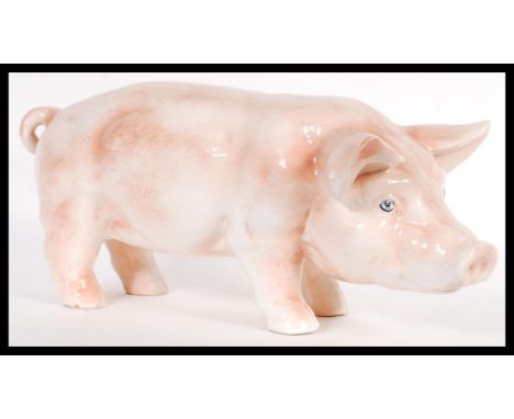 A large mid 20th Century butchers shop advertising point of sale ceramic pig, the pig on all fours with snout lowered. Measur