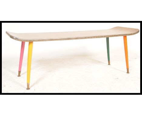 A vintage retro 20th Century teak coffee table of surfboard rectangular shape raised on tapering legs painted in different co
