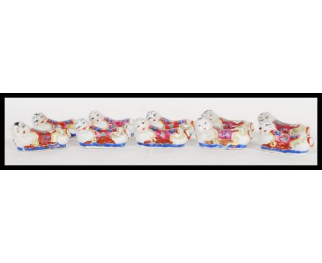 A set of ten early 20th Century ceramic chopstick rests in the form of Chinese opium pillow headrests&nbsp;hand decorated in 