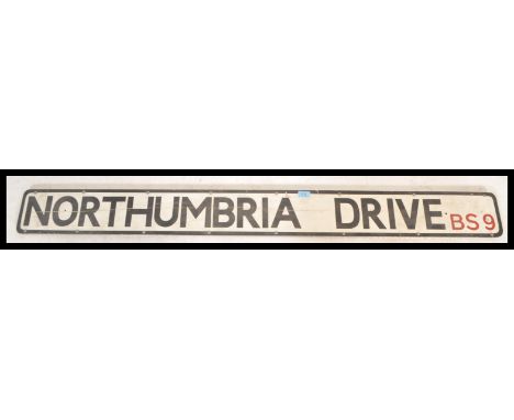 An original 20th century Industrial metal street sign for Northumbria Drive BS9 (Bristol) having black lettering and border o