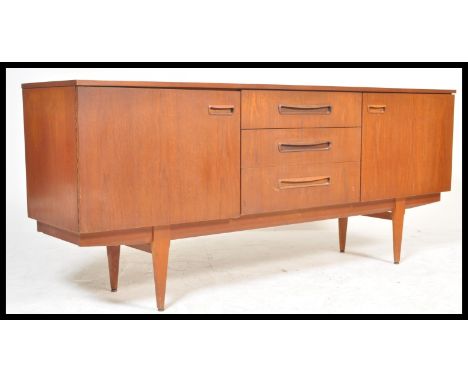 A vintage retro 20th Century teak wood Danish influence sideboard credenza having a central bank of three drawers flanked by 