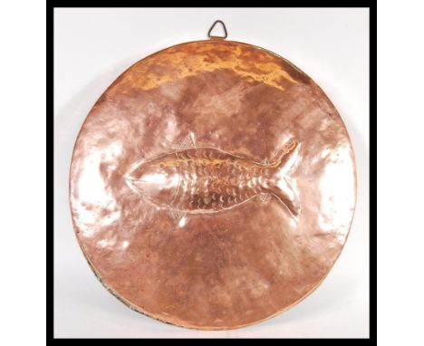 A vintage early 20th Century large circular copper fish mould / wall charger in the manner of Newlyn, the circular hand beate